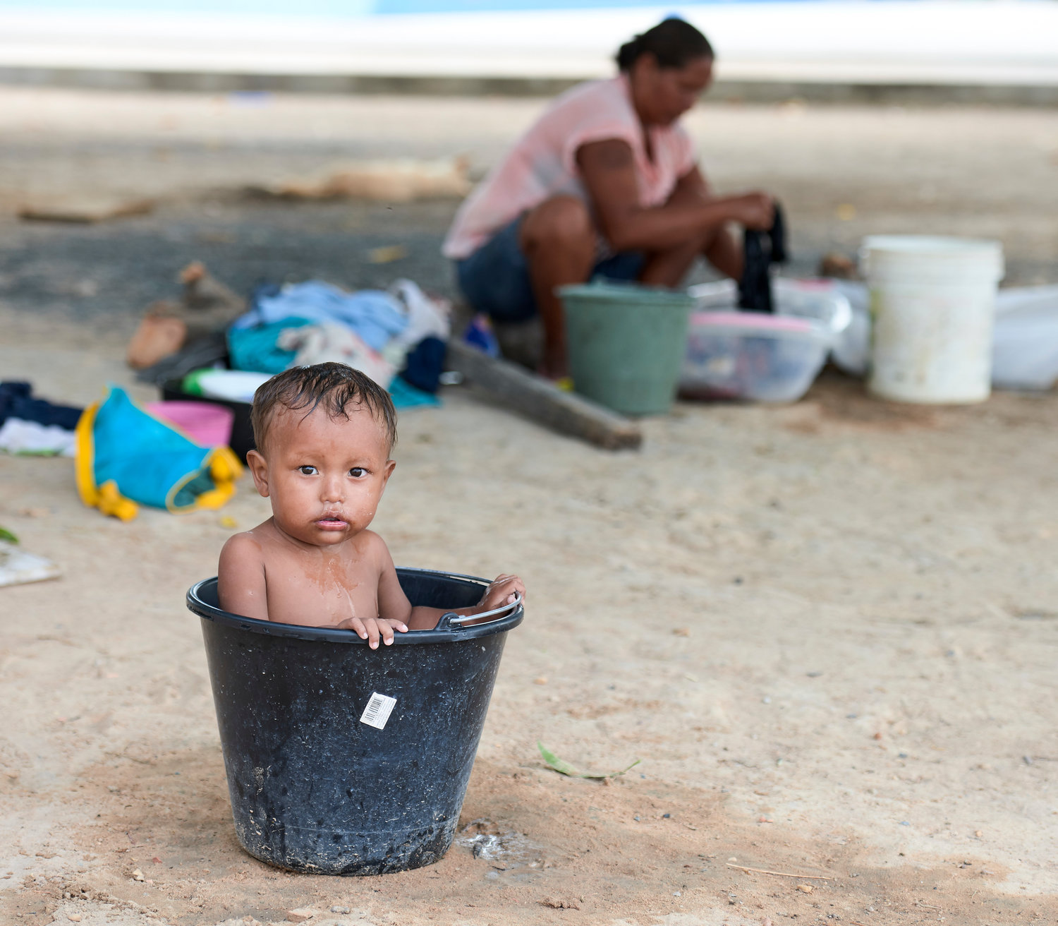Jesus Miguel Moraleda, a 1-year-old Warao indigenous boy from Venezuela, bathes in a bucket as his mother does laundry behind him April 2, 2019, in Boa Vista, Brazil. The Vatican released Pope Francis' postsynodal apostolic exhortation, "Querida Amazonia" (Beloved Amazonia), Feb. 12, 2020.